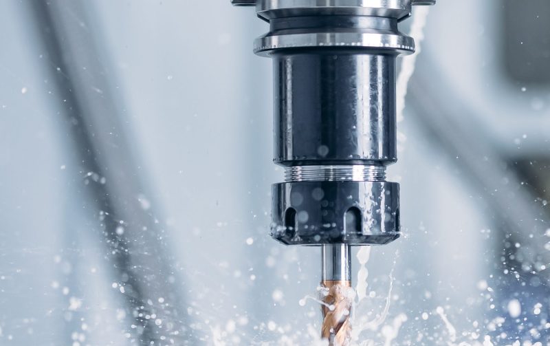 Working closeup CNC turning cutting metal Industry machine iron tools with splash water